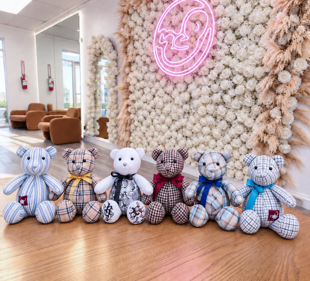 Memory bears handmade from patterned fabric, lined up in the studio